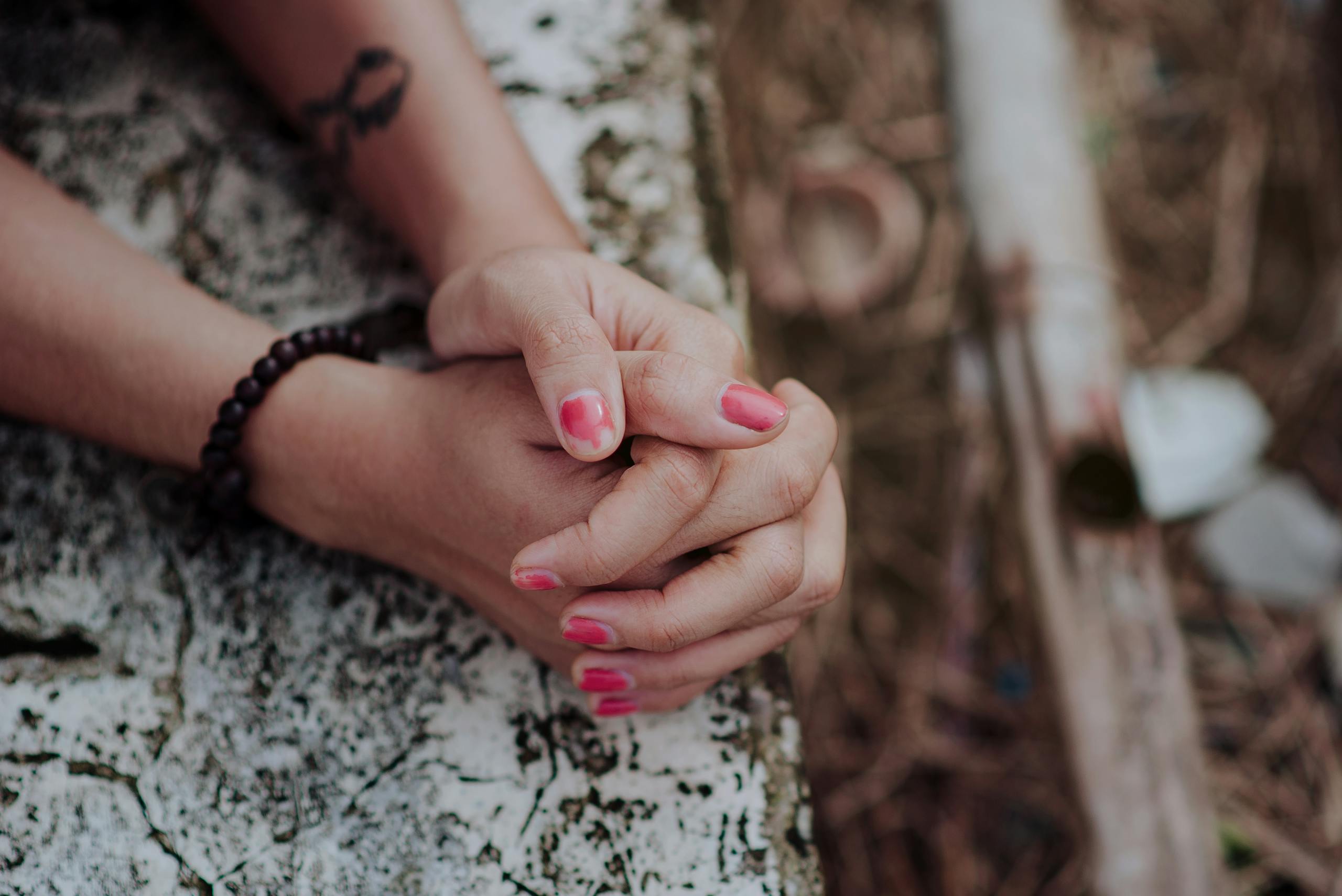 Depth of Field Photography of Human Hands on White Surface