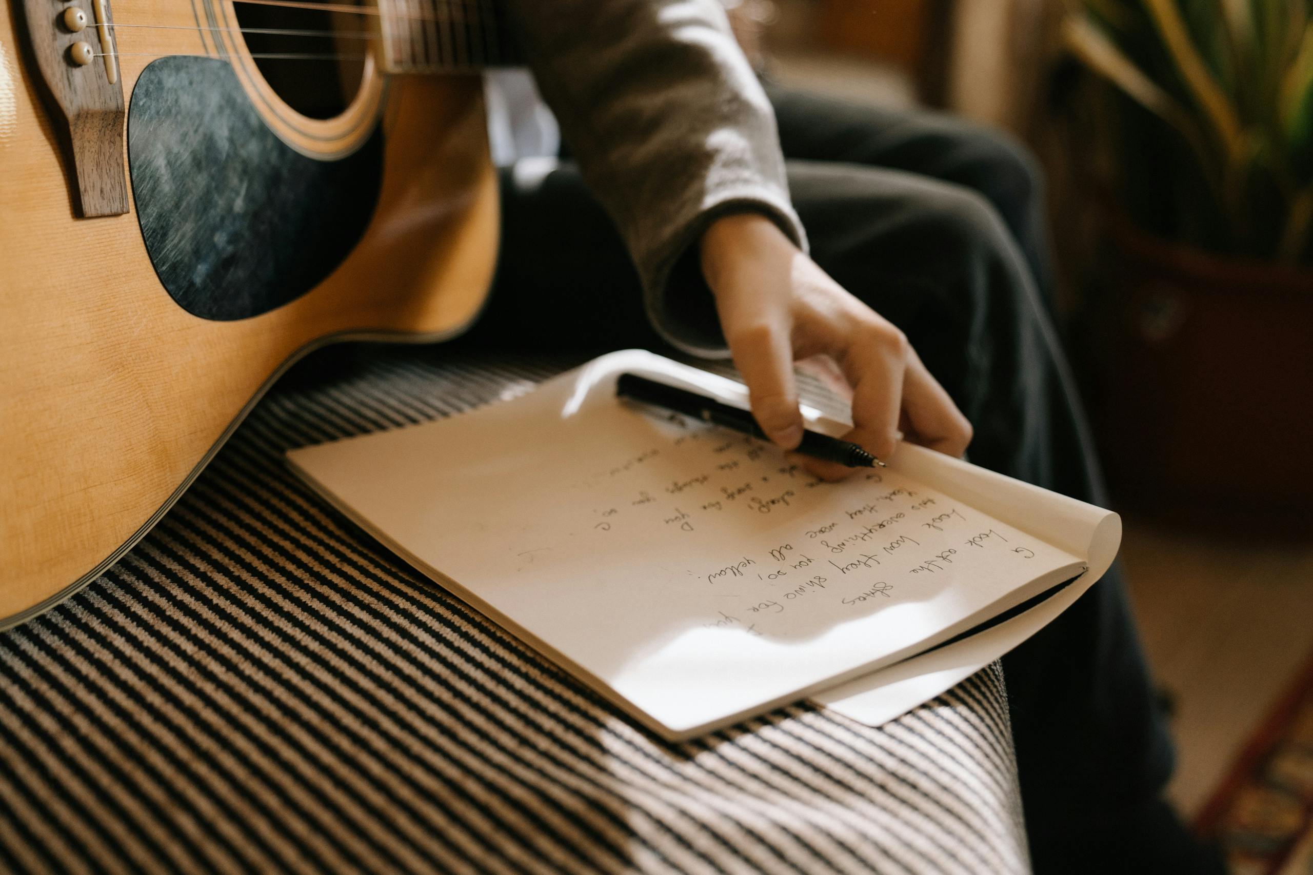 Person in Gray Long Sleeve Shirt Holding White Paper